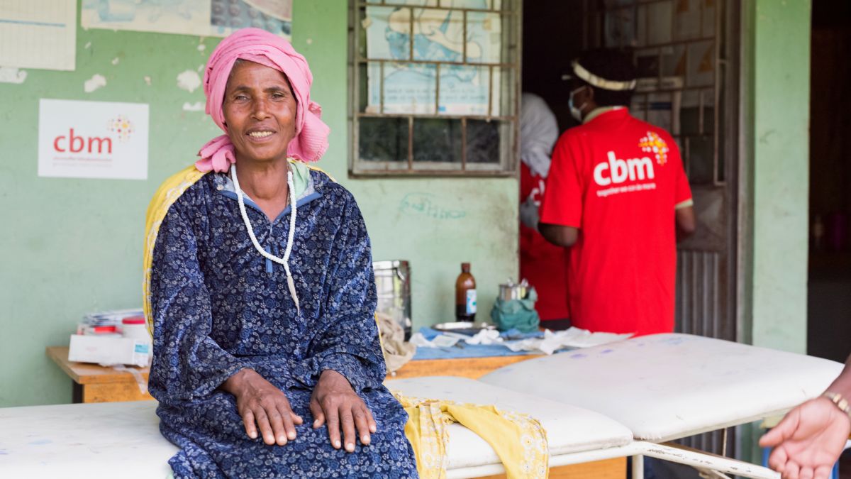 Woman sitting on a couch in front of a health centre
