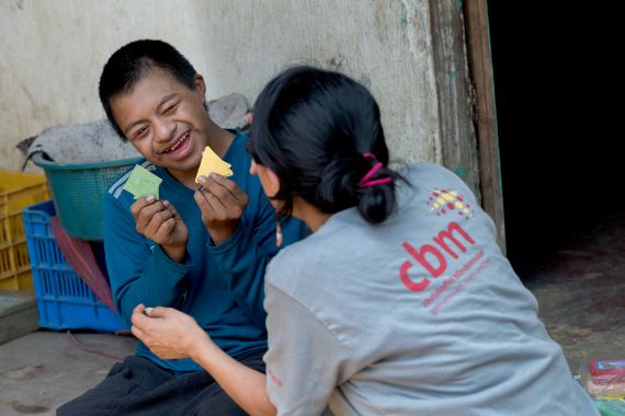 A child attending a therapy session with an adult