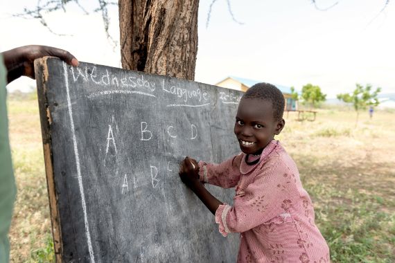 A child writing on a chalk board