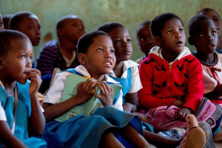 Sherifa, 8, who has cerebral palsy, receives support from CBM partner Saint John of God rehabilitation technician Clement Mkhomanya.