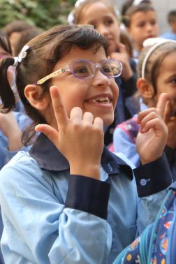 Alma ( aged 10) learning sign language at ASDC.