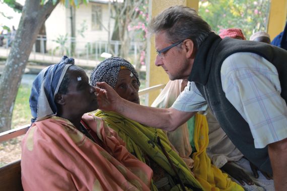 A doctor examining a patients eyes