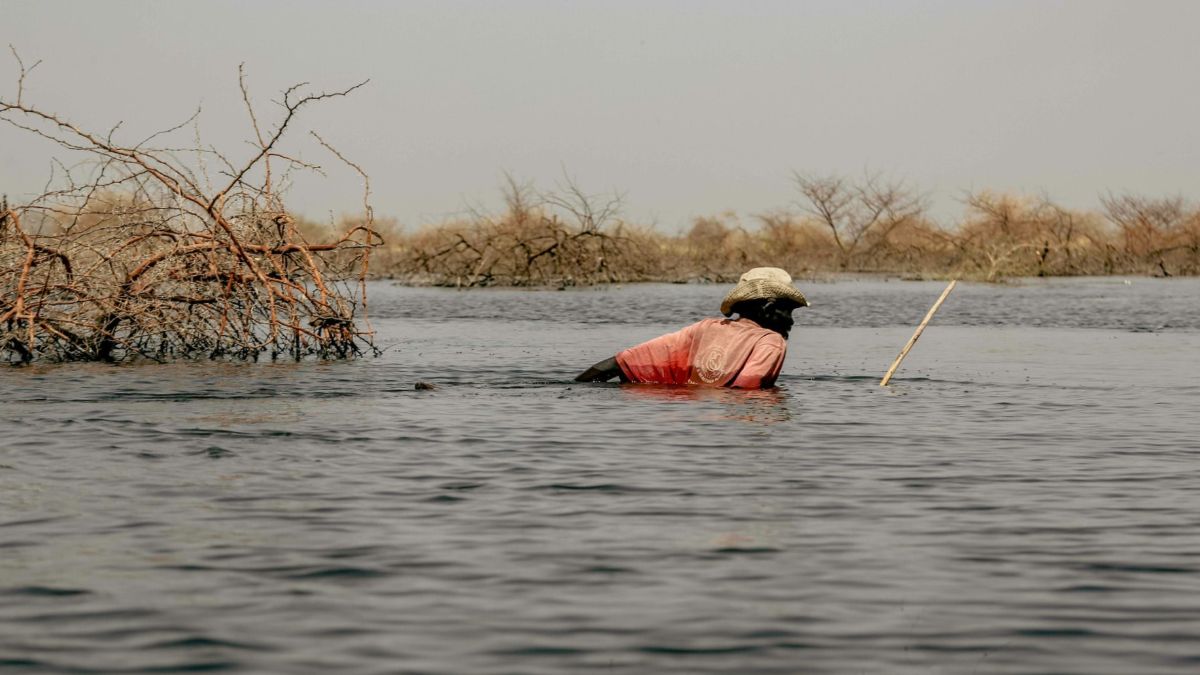 A man walking in a flooded field