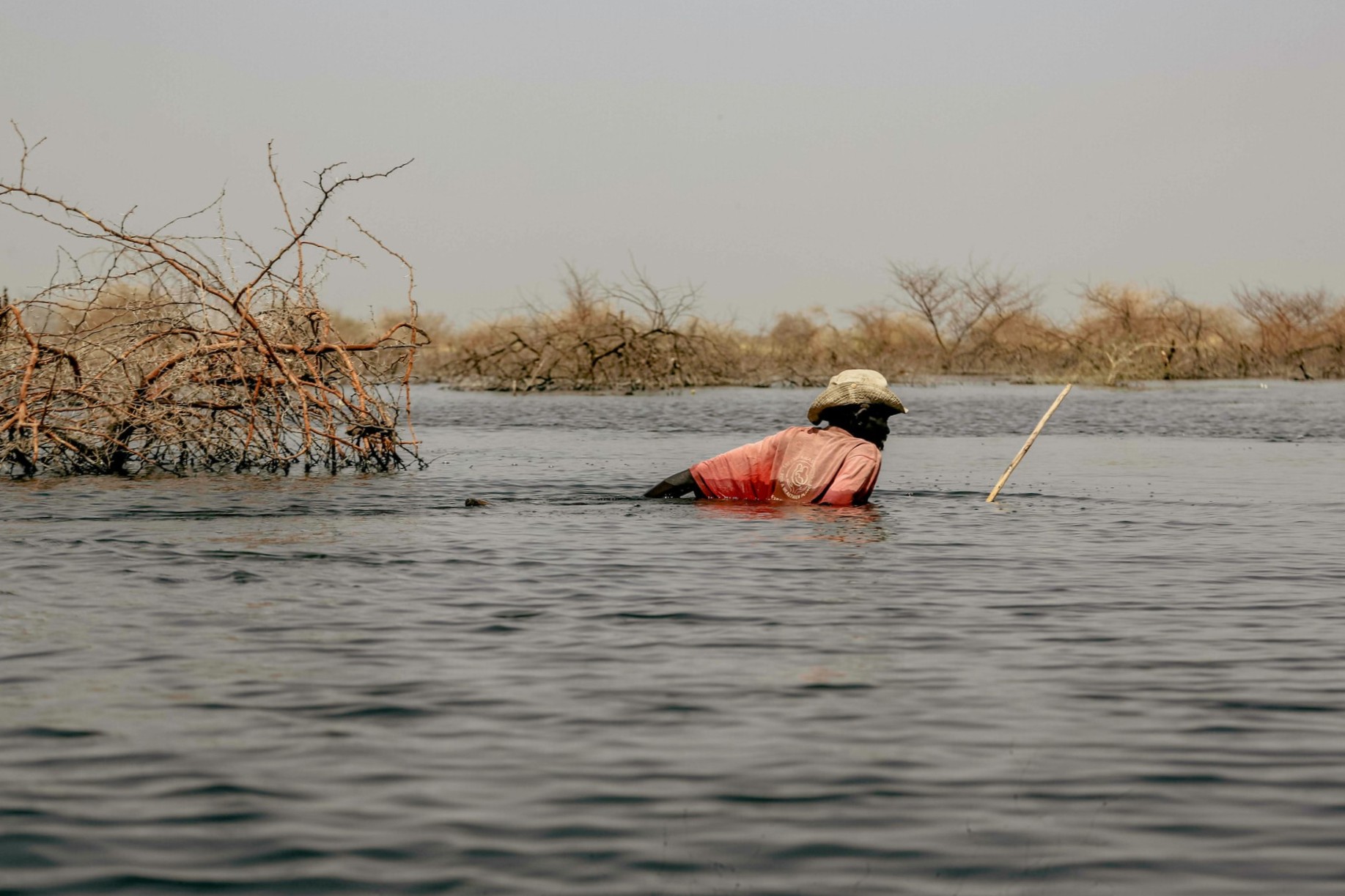 A man walking in a flooded field