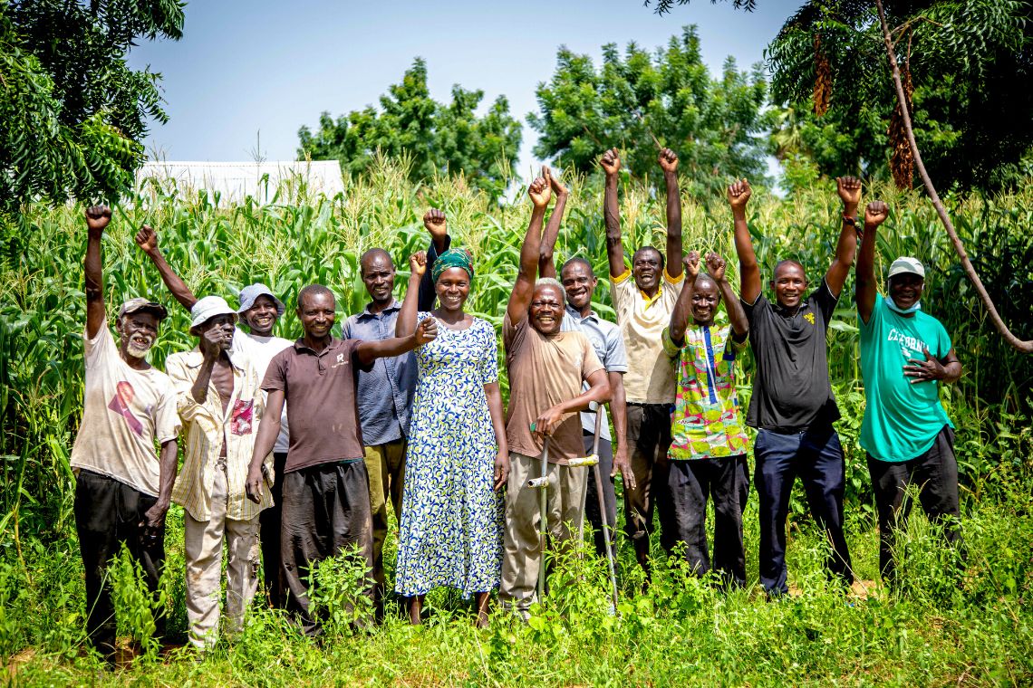 A group of farmers in front of a maize field 